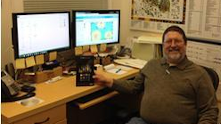 Bill Lawrence, RCDD, NTS, WD, an information-technology project manager at the Georgia Institute of Technology, with the Kindle he earned as winner of the CCCA's most recent Cable Check contest.