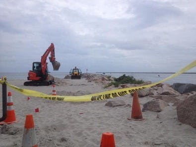 Photo credit: Rhode Island Public Radio. Investigators dig up an abandoned cable on Salty Brine Beach in Rhode Island, searching for the cause of an underground explosion. Research determined that the corroded cable indeed led to the explosion because of high hydrogen levels beneath the sand.