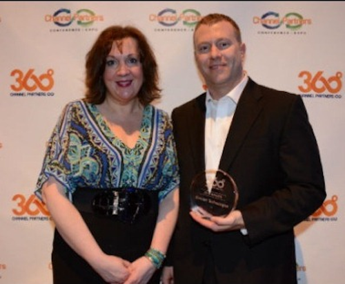 Joshua Shaw, Concert Technologies’ vice president of sales, accepts Concert’s Channel Partners 360 Business Value Award from Channel Partners magazine executive editor Lorna Garey.