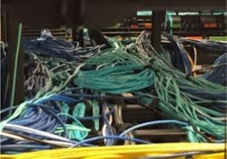 Machine Zone Inc. included this photo in its legal complaint against Peak Hosting. Machine Zone claims, among other accusations, that Peak employed a substandard cabling architecture and improper fiber management in a data center that hosted Machine Zone's Game of War. The complaint reads, 'Despite the fact that cables were wrapped around steel poles and bent at unacceptable angles ... any remediation of Peak's improper installation would put Machine Zone's live operations at risk for catastrophic failure.' Machine Zone Inc. included this photo in its legal complaint against Peak Hosting. Machine Zone claims, among other accusations, that Peak employed a substandard cabling architecture and improper fiber management in a data center that hosted Machine Zone's Game of War. The complaint reads, 'Despite the fact that cables were wrapped around steel poles and bent at unacceptable angles ... any remediation of Peak's improper installation would put Machine Zone's live operations at risk for catastrophic failure.'