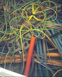 Through proper cable labeling, administration, and with the help of DCIM, network administrators can avoid a spaghetti effect like this one.