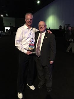 Dennis Mazaris (left) and Harry J. Pfister (right) pose on January 25, 2017, the evening when Mazaris received the Harry J. Pfister Award for Excellence in the Telecommunications Industry during the BICSI Winter Conference.