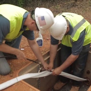 Installers place MaxCell fabric innerduct into an underground conduit. Successfully navigating congested conduit space will be a key element of preparing for 5G.