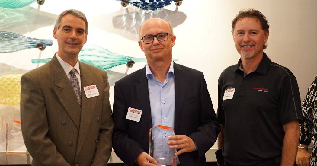 Rosenberger OSI&apos;s Clemens Wurster (center) and Ryan Chappell (right) pose with the company&apos;s 2018 Cabling Innovators Platinum Award.