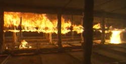 This image, taken from video footage of a test conducted at a nationally recognized test laboratory, shows flame spreading through a plenum space, fueled by cable that is not plenum-rated.