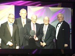 Roger Jette, center, accepts the Harry J. Pfister Award for Excellence in the Telecommunications Industry in January 2019. Roger Jette, center, accepts the Harry J. Pfister Award for Excellence in the Telecommunications Industry in January 2019.