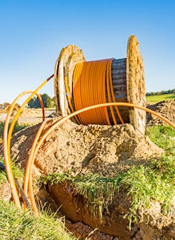 Rural construction site with a fiber-optic cable reel for broadband internet communication. Rural construction site with a fiber-optic cable reel for broadband internet communication.