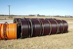 Fiber-optic cable waiting for deployment in a rural area. Fiber-optic cable waiting for deployment in a rural area.