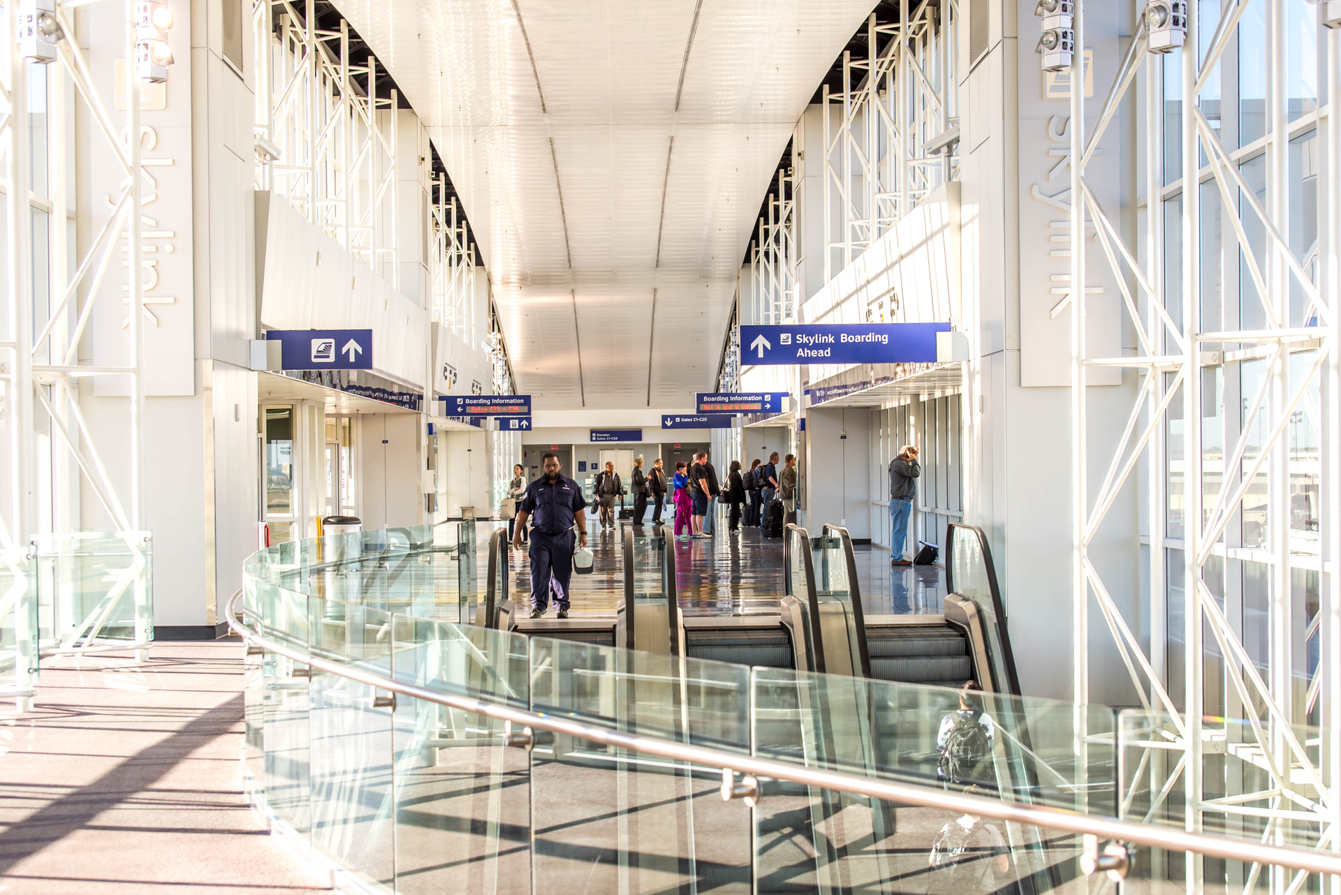 Passengers in the Skylink station at DFW Airport.