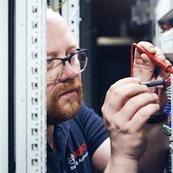 Marco Krause, a project manager for building automation at Bosch, works in a switch cabinet at Kaiserslautern University of Applied Sciences.