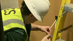 A competitor in the 2023 Cabling Skills Challenge terminates a Category 6A cable to a work-area outlet.