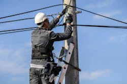 Telecommunications technician line worker on pole Telecommunications technician line worker on pole
