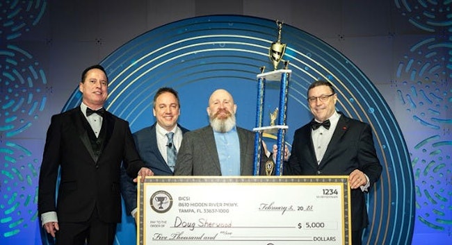 At BICSI's Annual Awards Banquet held February 5, Doug Sherwood, second from right, poses with his trophy and a check signifying his $5,000 prize for winning the 2025 BICSI Cabling Skills Challenge and being named Installer of the Year. Presenting the award to Sherwood are, from left, BICSI Board President-Elect William Foy, BICSI Board President David Richards, and BICSI Chief Executive Officer John Daniels.