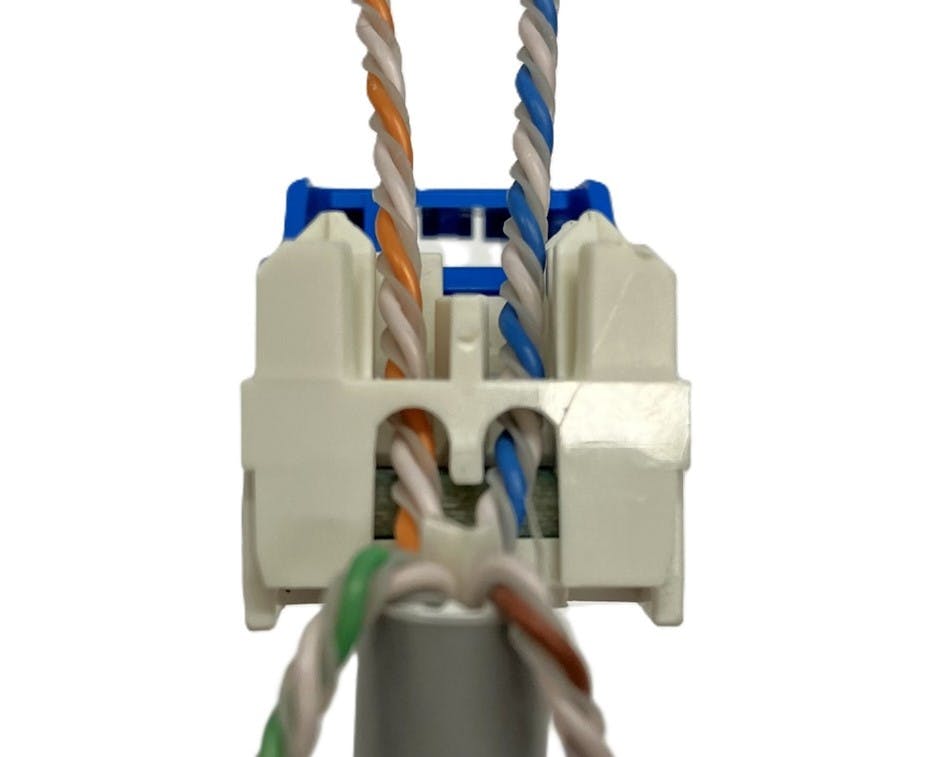 During the termination process, each pair of conductors is placed into the back of the Category 6 connector. The connector includes color-coded markings to indicate which conductor pair goes where.