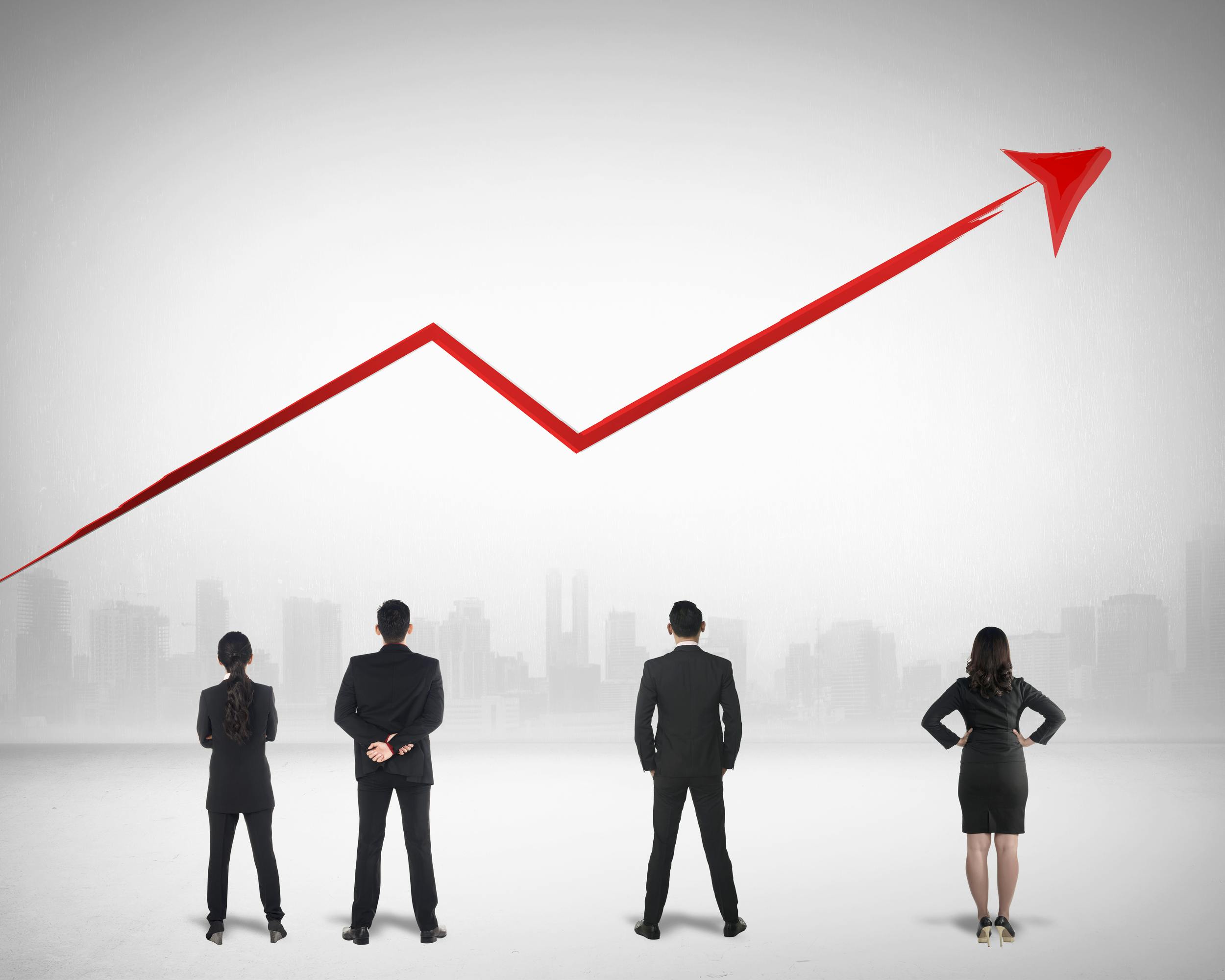 people in front of rising arrow on graph