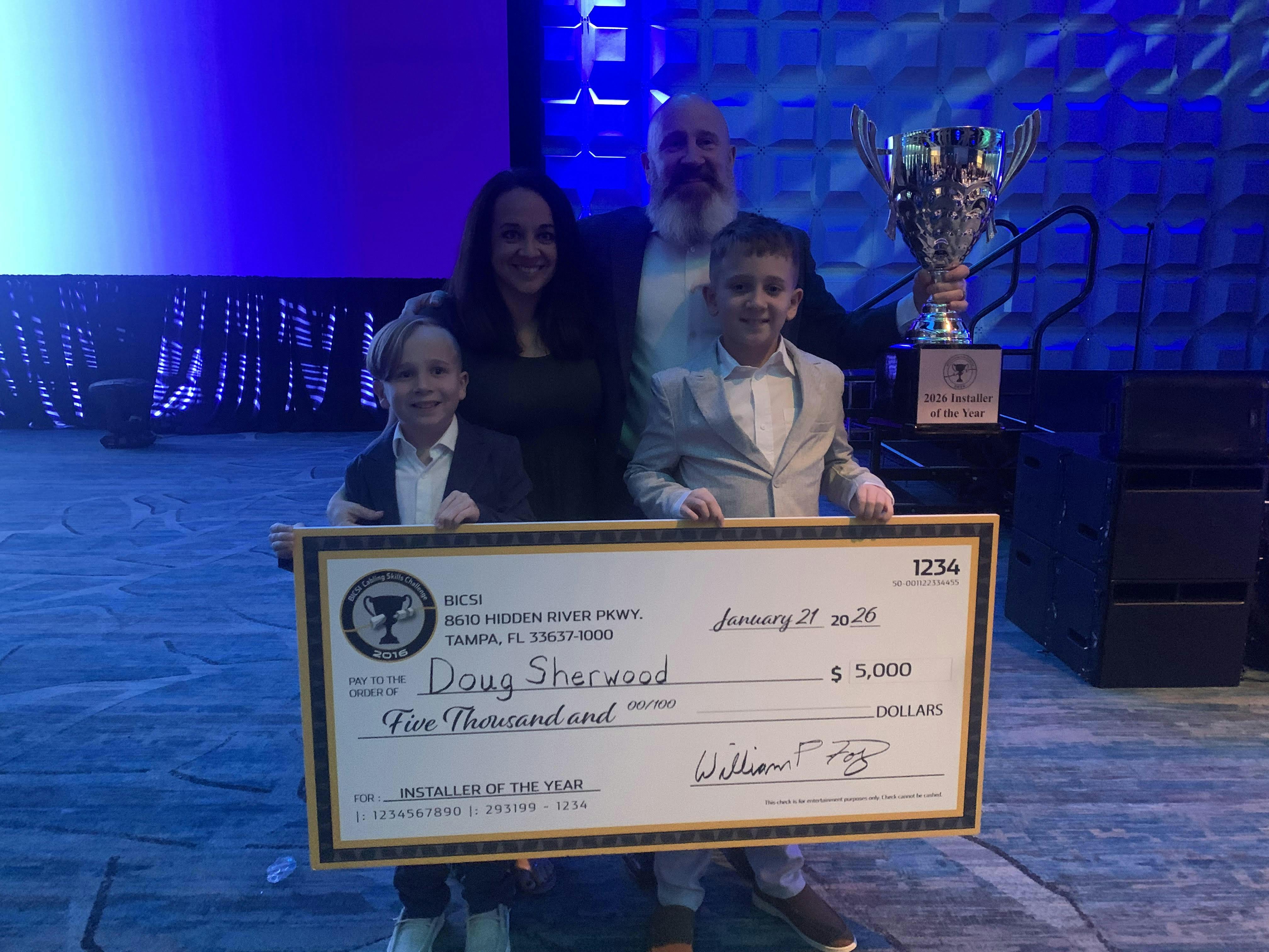During his acceptance speech as BICSI's 2026 Installer of the Year, Douglas Sherwood thanked his wife and children, who provided encouragement and lent him good luck charms. In 2025 Sherwood called his family to deliver the good news that he won the competition. This year, they witnessed it firsthand.