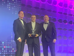 During BICSI's Annual Awards Banquet in January 2026, the surprise of the evening was when BICSI's Chief Executive Officer John Daniels (center) received the Presidential Eagle Award, which recognizes outstanding commitment to the association's mission. Daniels was unaware he would receive the award until his name was called. Left to right in this photo are current BICSI Board Chair William Foy; Daniels; and BICSI's Immediate Past President David M. Richards. During BICSI's Annual Awards Banquet in January 2026, the surprise of the evening was when BICSI's Chief Executive Officer John Daniels (center) received the Presidential Eagle Award, which recognizes outstanding commitment to the association's mission. Daniels was unaware he would receive the award until his name was called. Left to right in this photo are current BICSI Board Chair William Foy; Daniels; and BICSI's Immediate Past President David M. Richards.