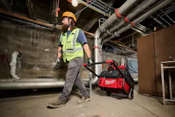 Technician Moving Milwaukee Tool Roll-On Power Supply Technician Moving Milwaukee Tool Roll-On Power Supply